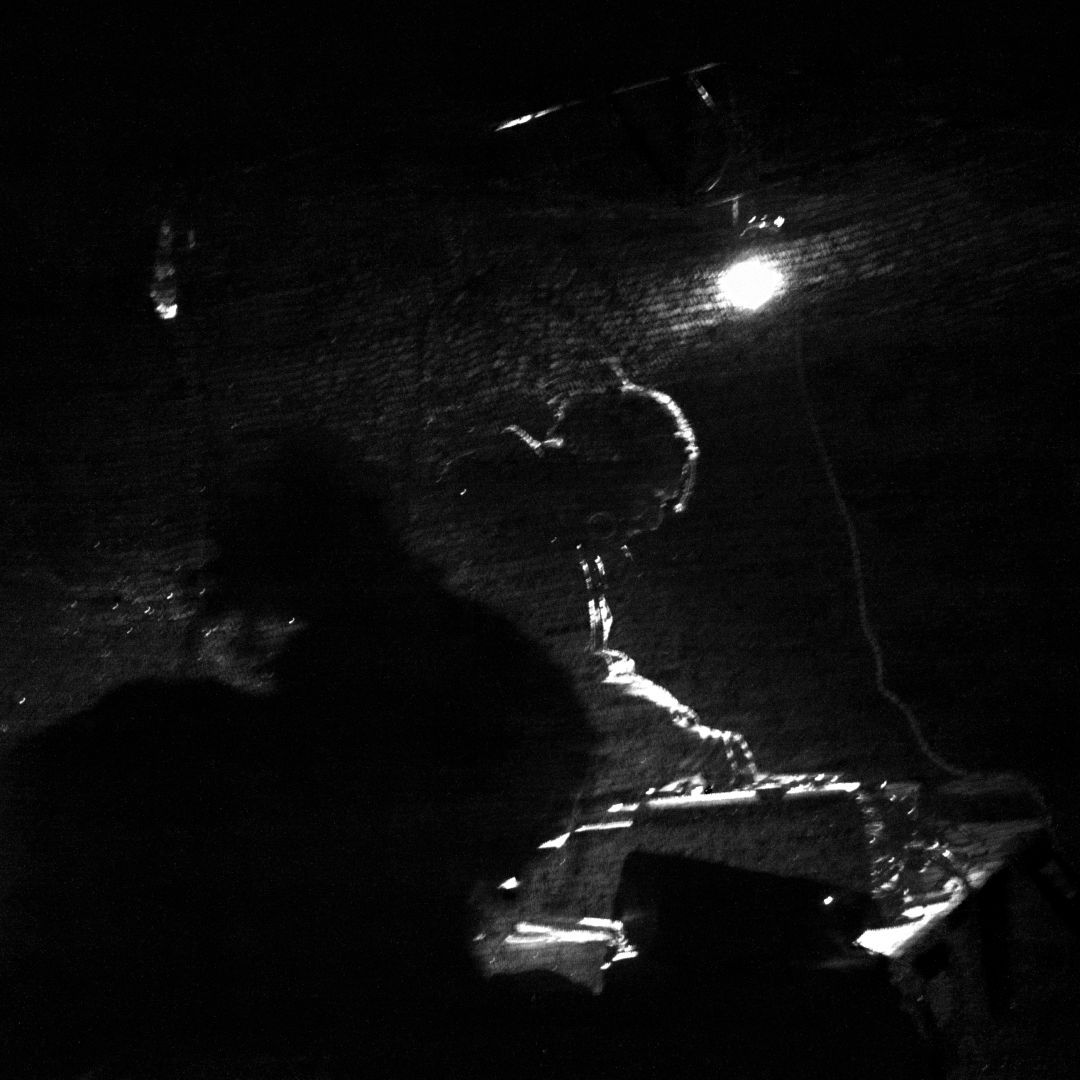 DJ playing music in dim lit pavilion